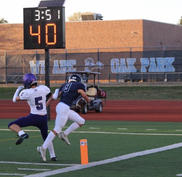 Freshman running back Eli Schumann, No. 9, runs in for a touchdown against the Northtown  Hornets. Schumann said he has been playing football for eight years. He hopes to play D1 at Michigan. One thing that stuck out to Eli during the game was “the bond with his teammates.” The final score was 21-8, Oak Park taking the win on Monday, Oct. 14.
